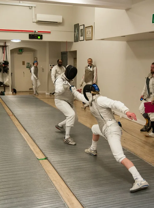Two fencers contesting a close bout