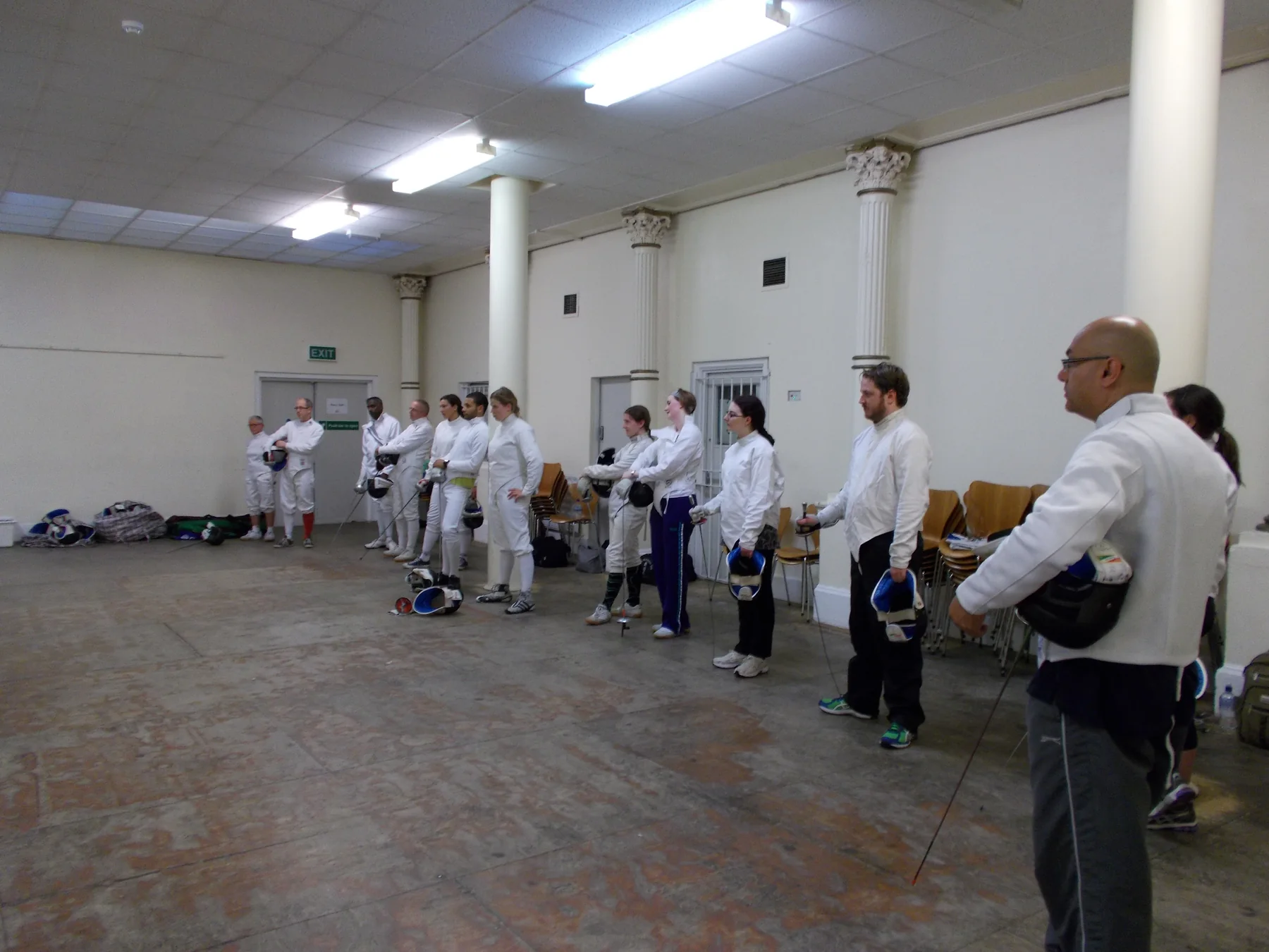Club members lined up for a group fencing lesson
