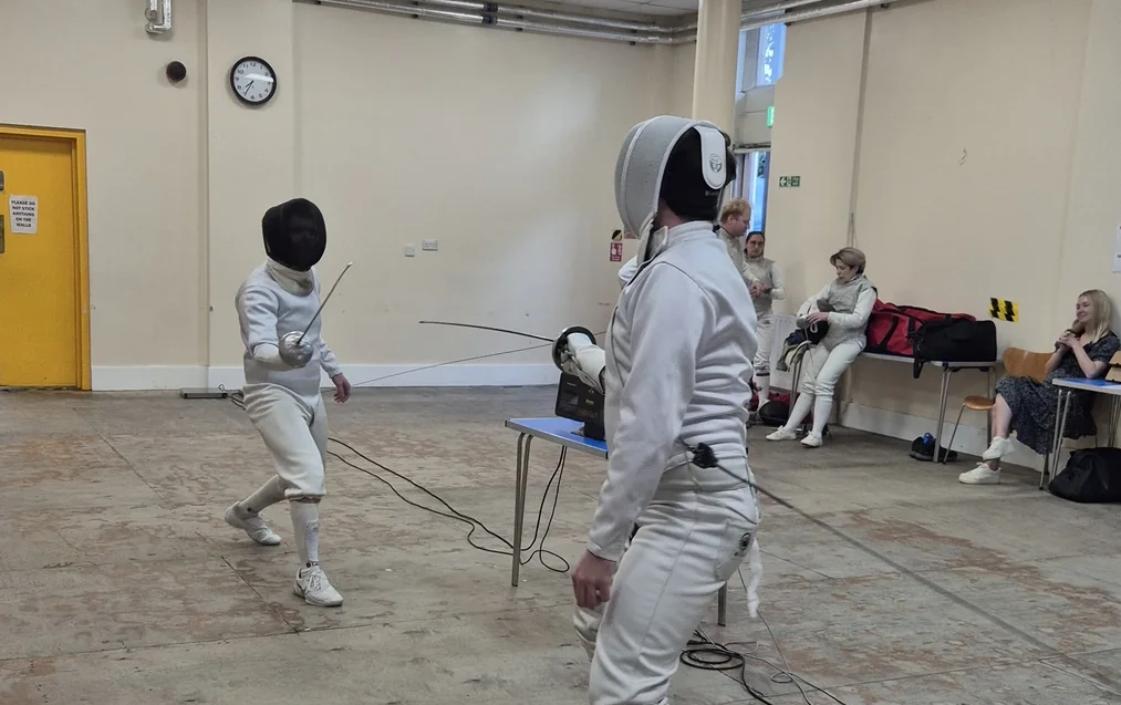 Two foil fencers during a bout at the club