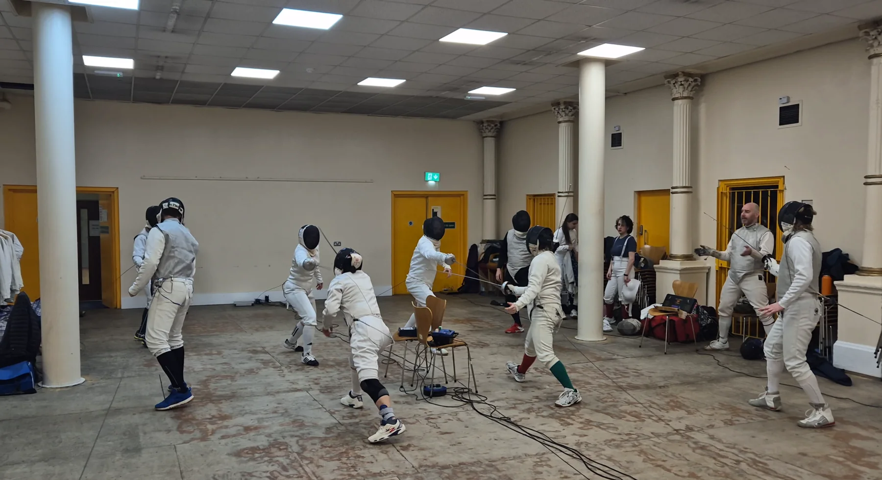 A busy group fencing practice at Morley Blades